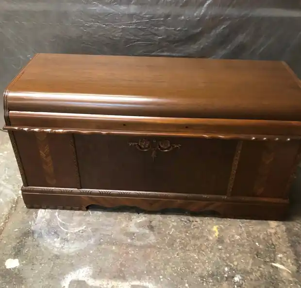 Waterfall cedar chest with a refinished walnut top and figured front, on the shop floor