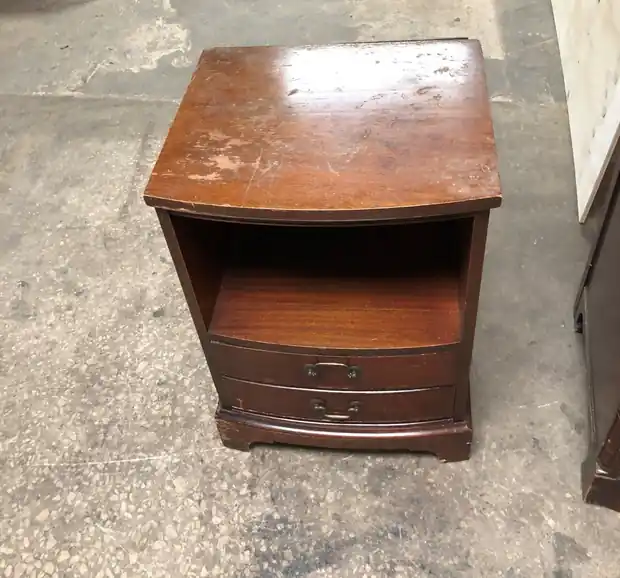 Open-shelf bedside table before refinishing, the top scuffed and worn