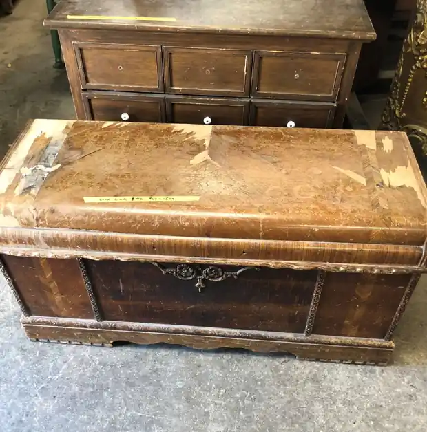 Waterfall cedar chest before refinishing, the lid finish worn through