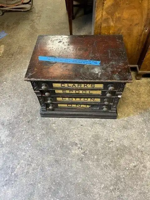 Spool cotton cabinet before refinishing, dark and worn on top