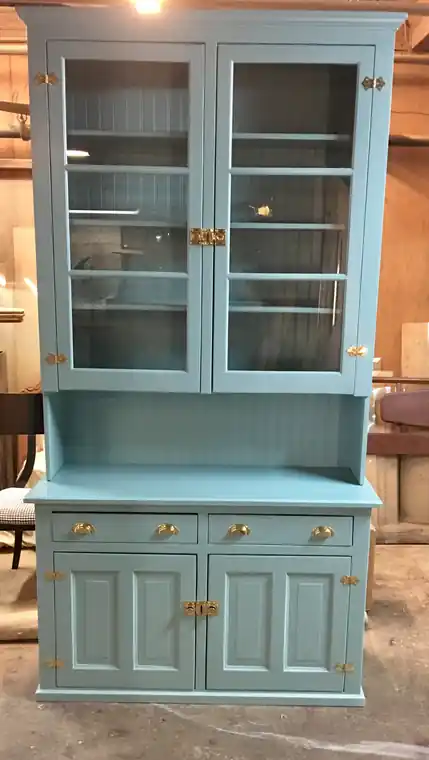 Glass-front hutch painted teal with brass hardware