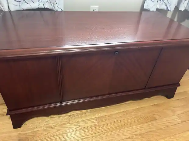 Mahogany cedar chest with a matched-veneer front, finished and set on a hardwood floor