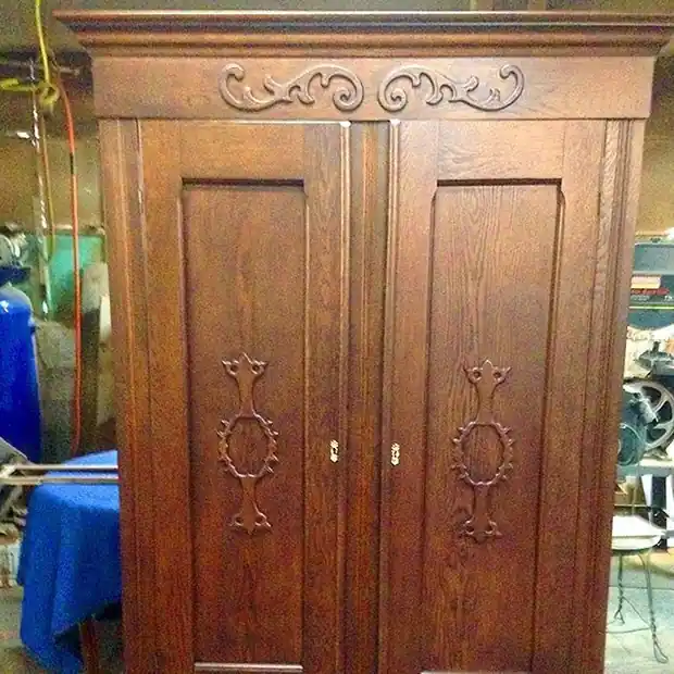 Tall oak wardrobe with carved door panels