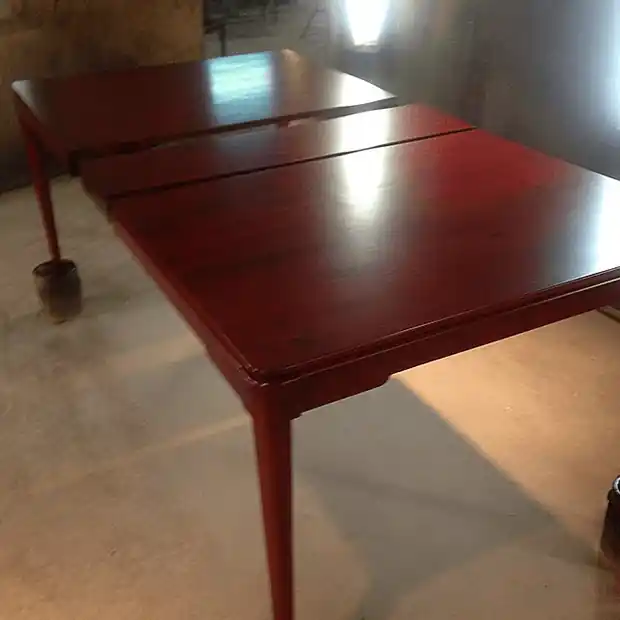 Mahogany dining table with its leaf in, the top polished deep red