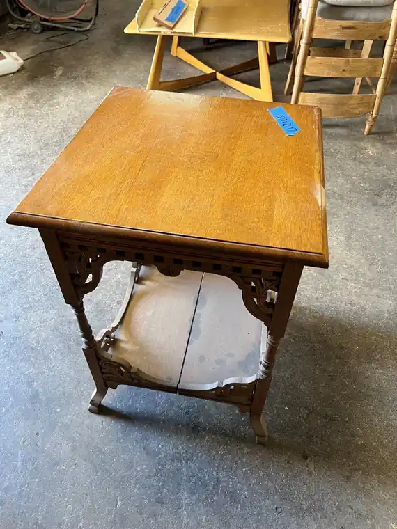 Square oak parlor table with a fretwork apron and a lower shelf