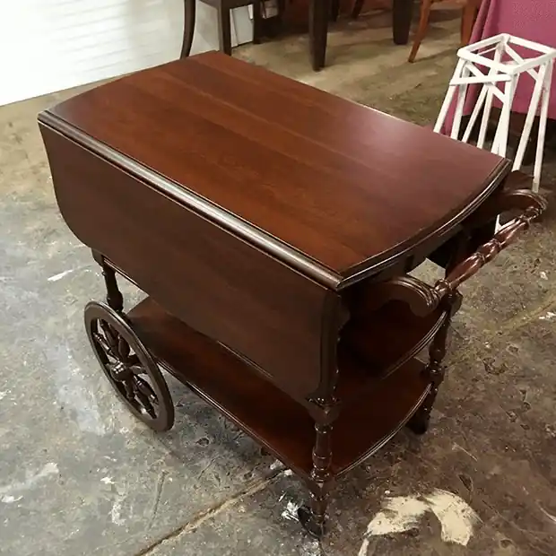 Mahogany drop-leaf tea cart on spoked wheels
