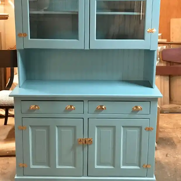 Hutch painted teal with glass upper doors and brass pulls