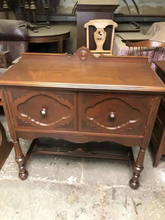 Walnut washstand with a scrolled backsplash and carved door panels
